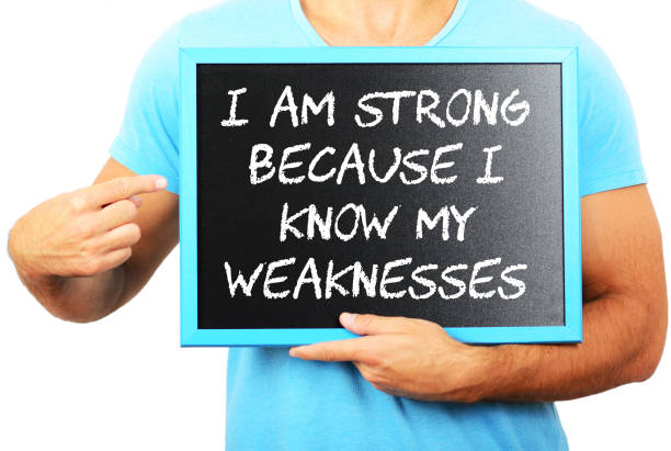 istock Man holding blackboard in hands and pointing the word I AM STRONG BECAUSE I KNOW MY WEAKNESESS 656751900
