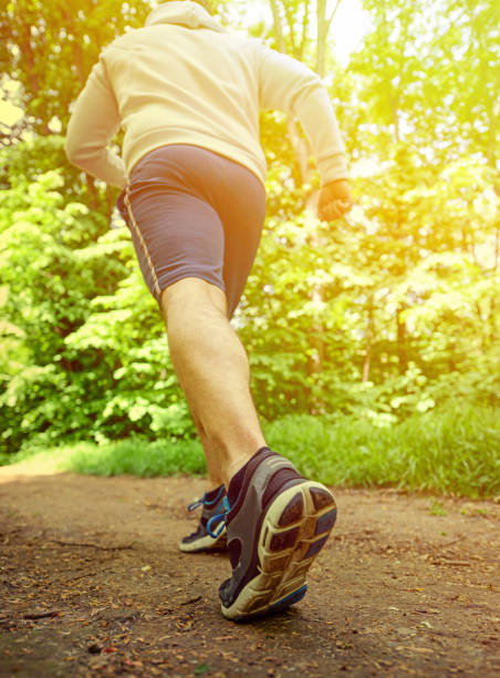 istock Runner feet running on road closeup on shoe 656752360