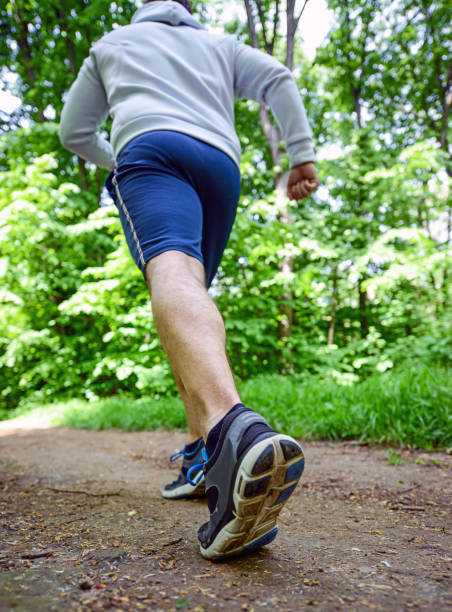 istock Runner feet running on road closeup on shoe 656752364