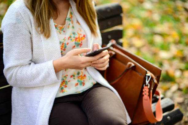 istock Woman using mobile smart phone in the park 656752770