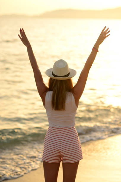 istock Happy Woman Jumping in Sea Sunset 656752894