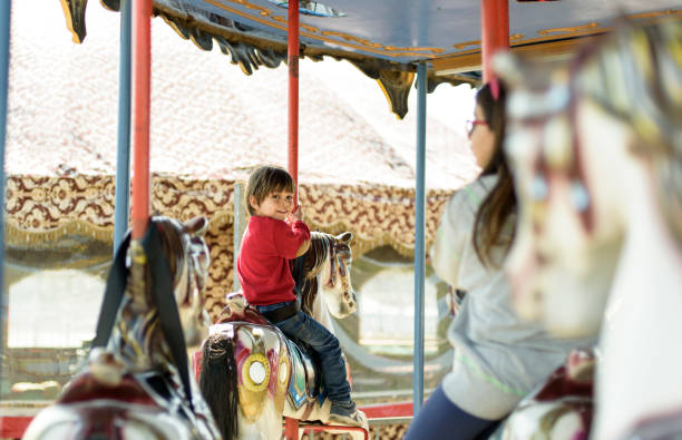 istock Little boy and girl on carousel 656757280
