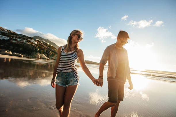istock Loving couple walking on sea shore holding hands 656757466