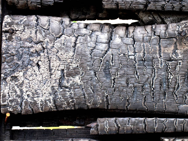 istock Fire heat burnt black coal ruined wood log house 656759974