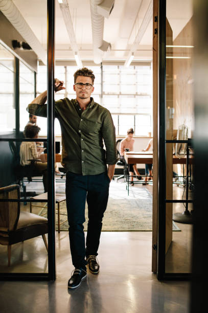 istock Young man standing in doorway at startup office 656760244