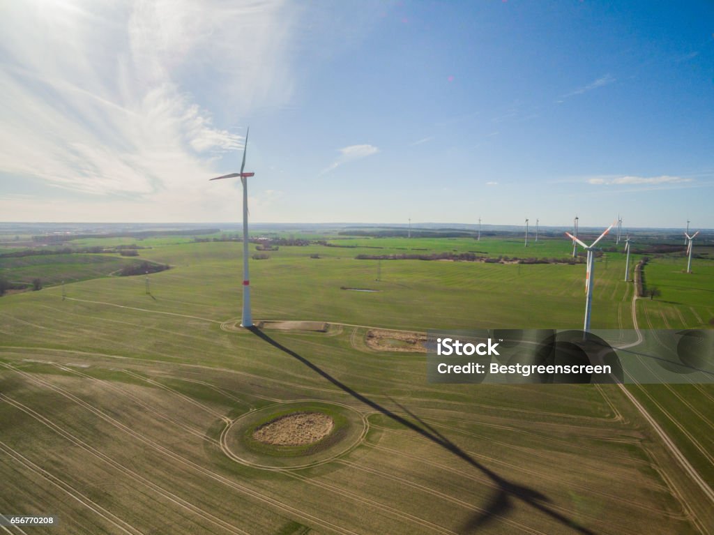 aerial view of a wind turbine in agriculture fields with blue sky Aerial View Stock Photo