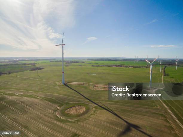 Aerial View Of A Wind Turbine In Agriculture Fields With Blue Sky Stock Photo - Download Image Now