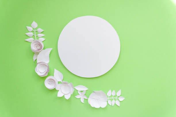 istock Round frame with white paper flowers on green background. Cut from paper. 656773452