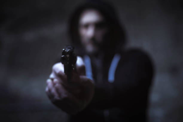 istock Hateful street hooligan aiming his gun for someone 656774082