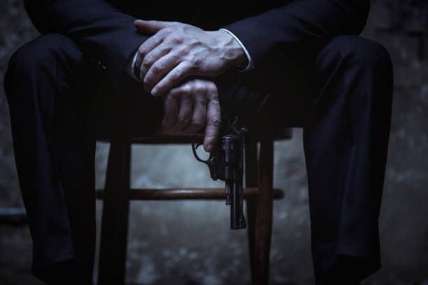 istock Dangerous elegant villain holing a gun 656783402