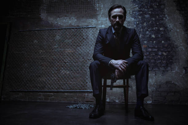 istock Charming villain sitting in dark room 656783452