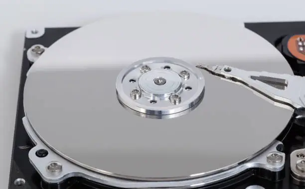 Photo of Open hard drive with magnetic disk and writing head