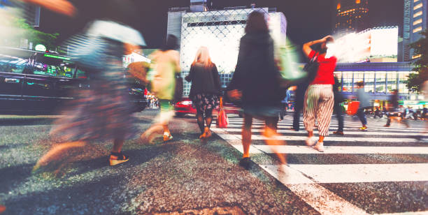 istock Motion blurred people walking in the city at night 656783808