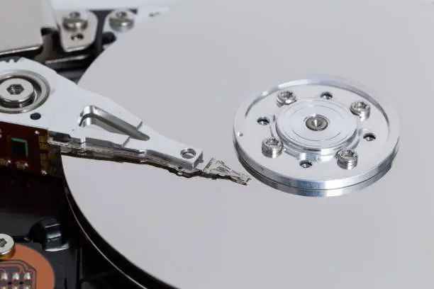 Photo of Open hard drive with magnetic disk and writing head