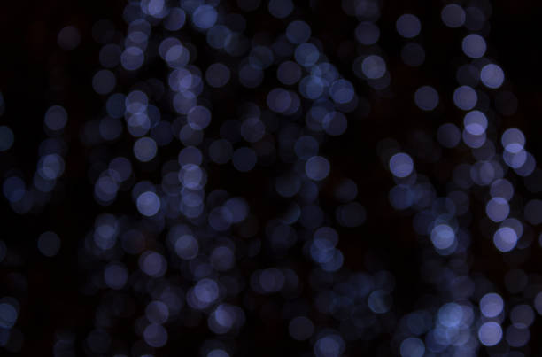 istock Lilac bokeh of garlands with black backdrop. Blur  abstract background. 656786714