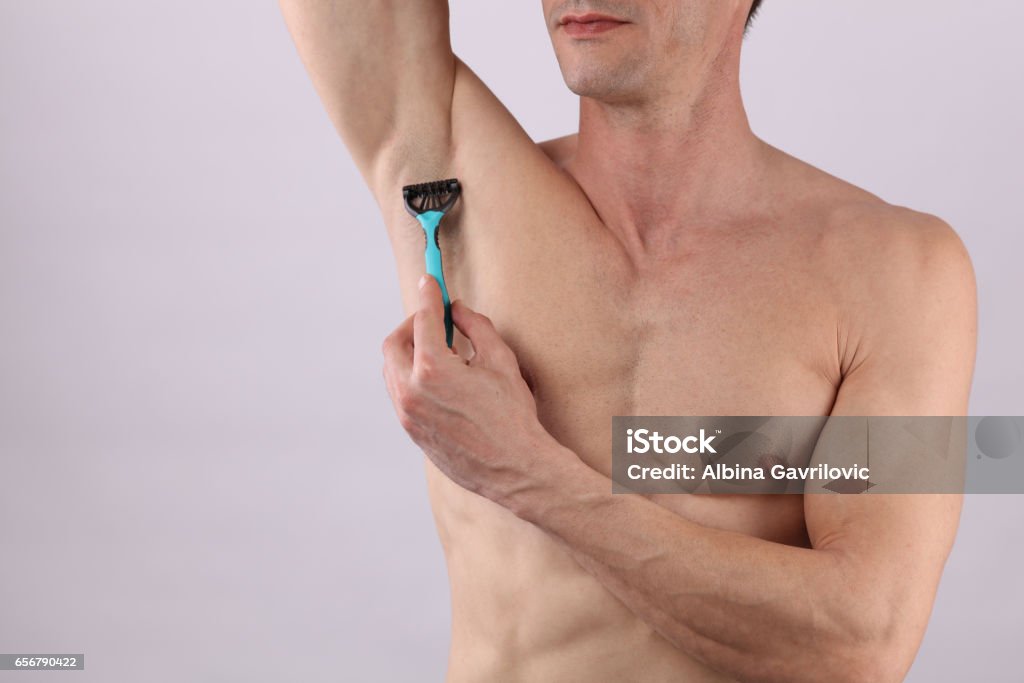 Male Body Hair Removal Attractive Muscular Man Using Razor To Remove Hair  From His Armpit Stock Photo - Download Image Now - iStock