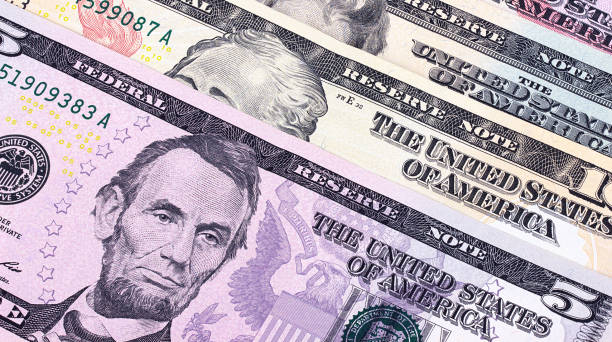 istock American dollar bills of different denominations abstract background. 656790468