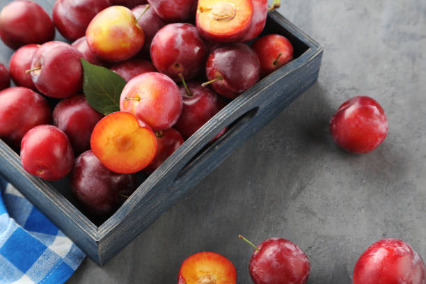 istock Fresh plums on a grey wooden table 656793728