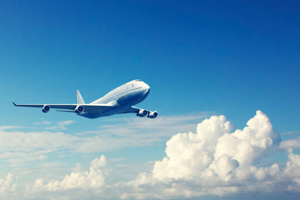 commercial airplane flying over the clouds