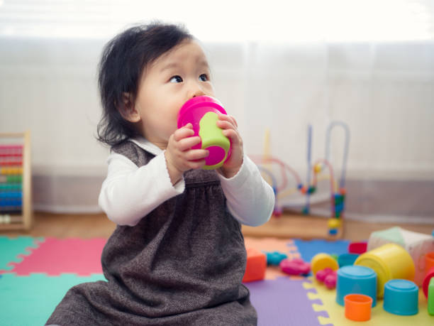 10+ Asian Baby Holding Sippy Cup Stock Photos, Pictures & Royalty-Free  Images - iStock