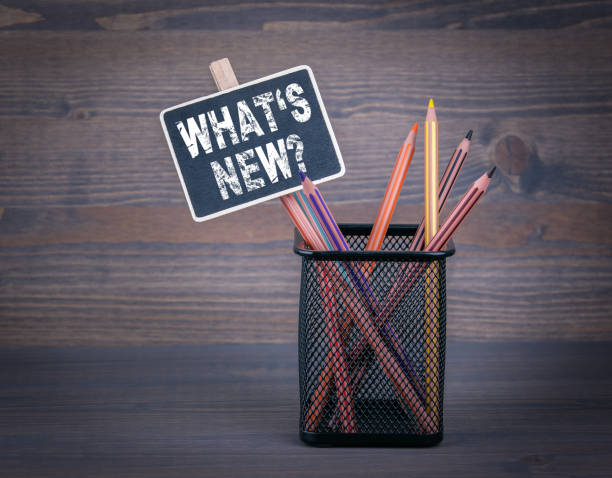 istock What's New. A small blackboard chalk and colored pencil on wood background 656801418