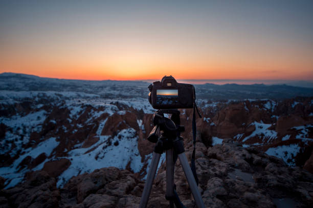 istock Professional digital camera and tripod on top mountain. 656802204