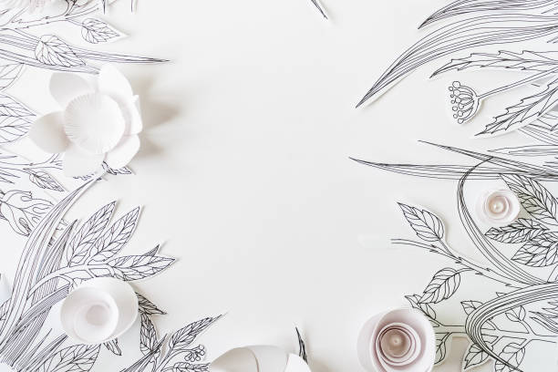 3d white paper flowers with painted leaves and stems on the white background