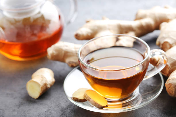 istock Cup of tea with ginger root on grey wooden table 656806944