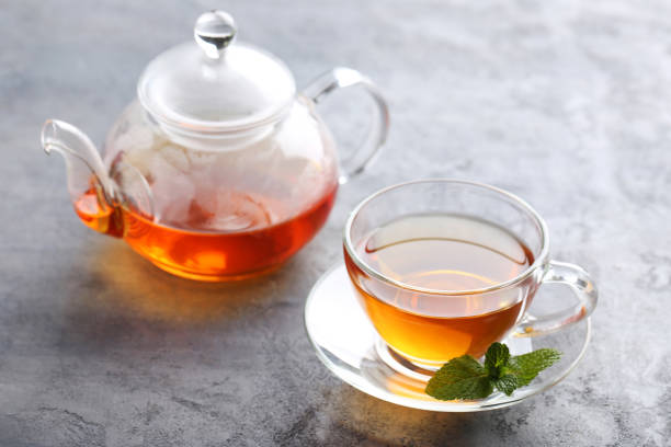 istock Cup of tea with mint leaf on grey wooden table 656807162