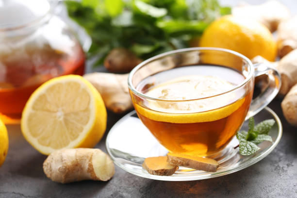 istock Cup of tea with ginger root and lemon on grey wooden table 656807186