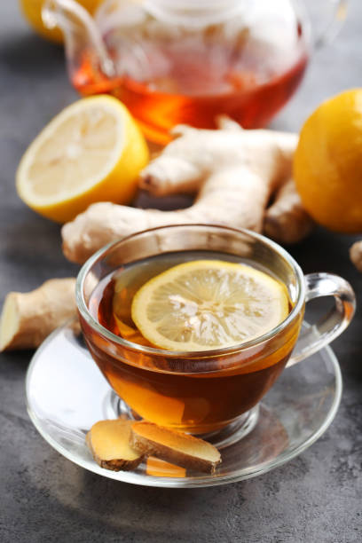 istock Cup of tea with ginger root and lemon on grey wooden table 656807372