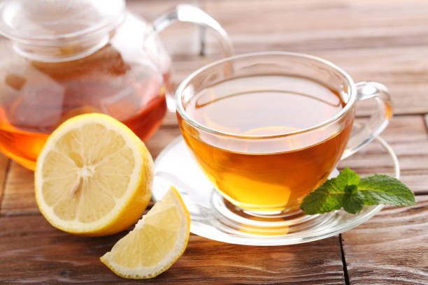 istock Cup of tea with mint and lemon on brown wooden table 656807458