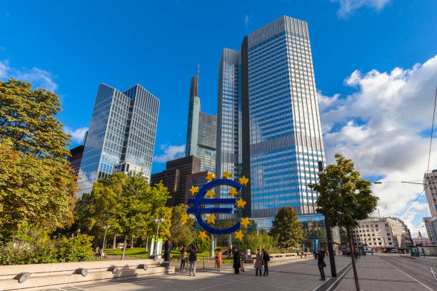 Tourists taking photo in front of ECB Headquarter Frankfurt am Main, Germany - October 2, 2016 - Tourists taking photo of the huge sculpture of the Euro sign in front of the European Central Bank headquarter building in Franfurt am Main, Hesse, Germany photography hessen germany central europe stock pictures, royalty-free photos & images