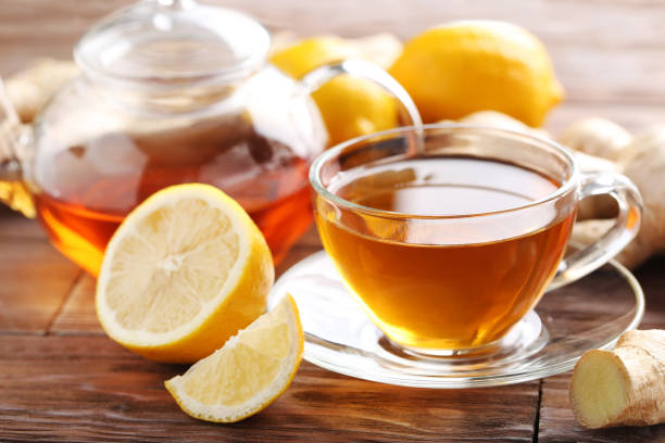 istock Cup of tea with ginger root and lemon on brown wooden table 656807926