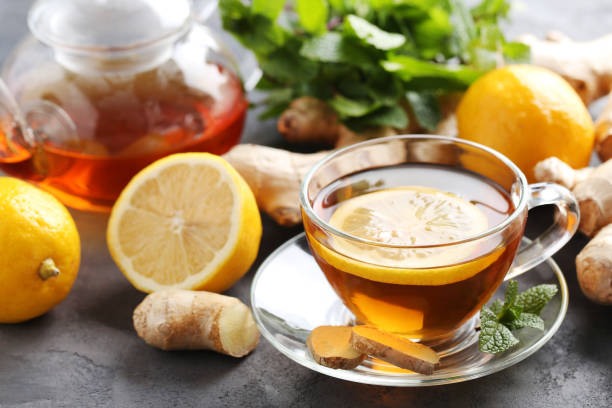 istock Cup of tea with ginger root and lemon on grey wooden table 656808022