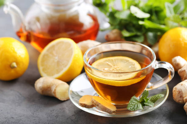 istock Cup of tea with ginger root and lemon on grey wooden table 656808460