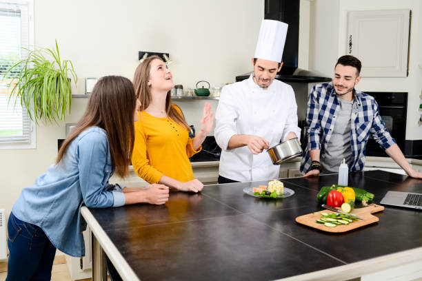 istock professional personal chef cook in customer's private kitchen house giving a cooking lesson to young people at home 656810976