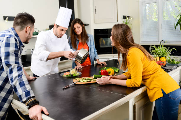 istock professional personal chef cook in customer's private kitchen house giving a cooking lesson to young people at home 656810978