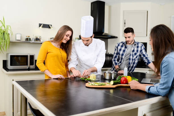 istock professional personal chef cook in customer's private kitchen house giving a cooking lesson to young people at home 656810984