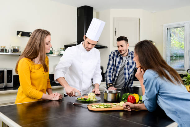 istock professional personal chef cook in customer's private kitchen house giving a cooking lesson to young people at home 656810992