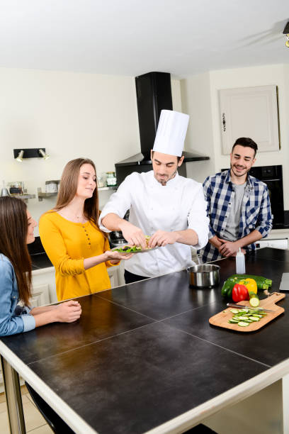 istock professional personal chef cook in customer's private kitchen house giving a cooking lesson to young people at home 656811150