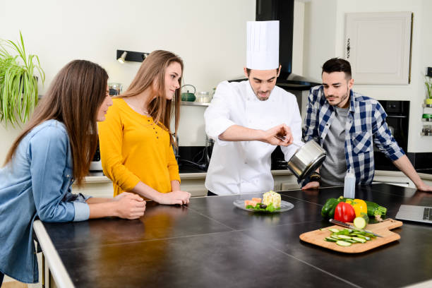 istock professional personal chef cook in customer's private kitchen house giving a cooking lesson to young people at home 656811166