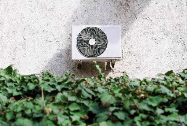istock air conditioning unit behind a green leaves wall 656813932
