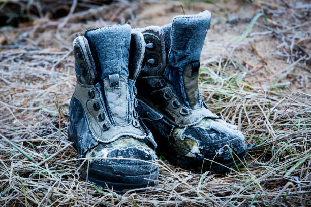 istock old lost frozen boots on meadow 656814590