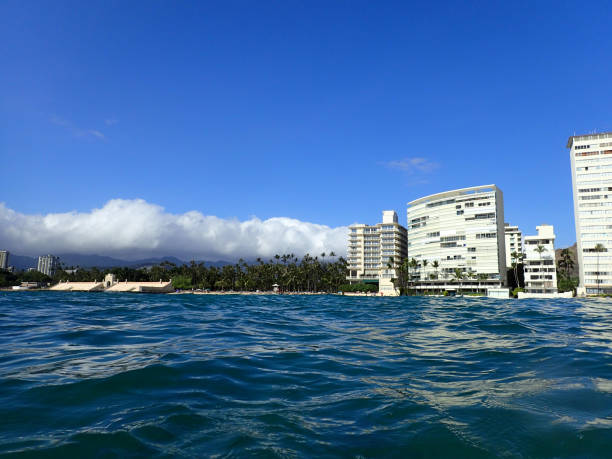 Wavy water on ocean off Kaimana Beach with hotels and condos