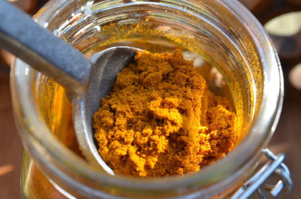 istock spoon in spice jar of turmeric powder 656819410