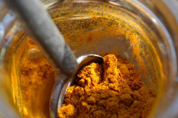istock spoon in spice jar of turmeric powder 656819434
