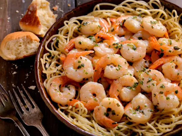 Shrimp Sauteed in a Wine, garlic, butter Sauce, served with Pasta