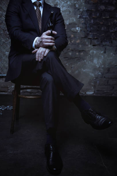 istock Attractive villain sitting with his legs crossed 656838408