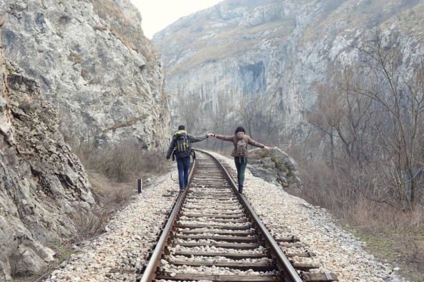 istock Couple walking on railroad tracks and holding hands 656838486